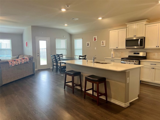 6413 Tudor Pl, Celina, TX 76227 - kitchen with stainless steel appliances, a sink, open floor plan, lofted ceiling, and dark wood finished floors