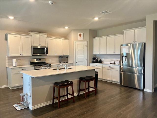 6413 Tudor Pl, Celina, TX 76227 - kitchen featuring appliances with stainless steel finishes, a sink, white cabinetry, dark wood-style floors, and decorative backsplash