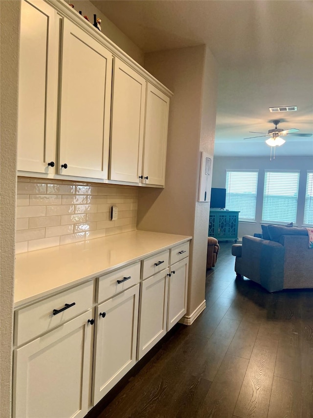 6413 Tudor Pl, Celina, TX 76227 - kitchen with dark wood finished floors, ceiling fan, white cabinetry, backsplash, and light countertops