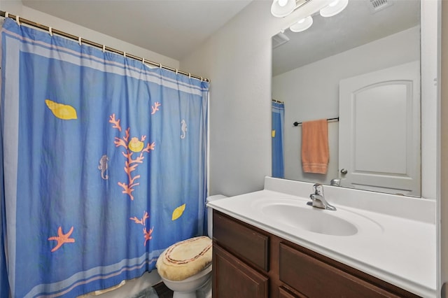 1445 Macy Ln, Dallas, TX 75253 - bathroom featuring toilet, vanity, and a shower with shower curtain