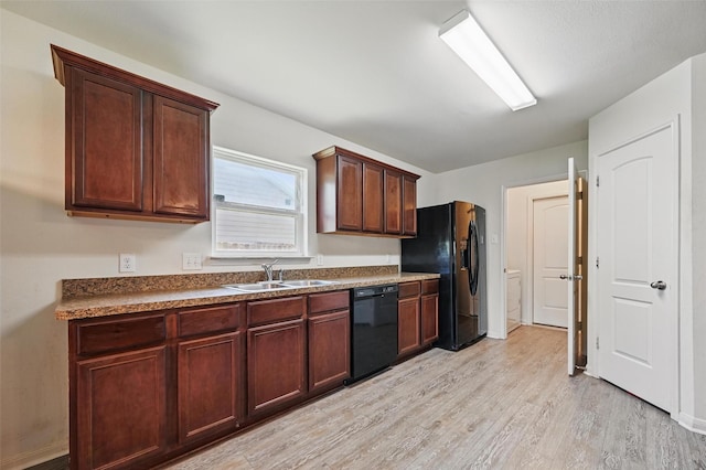 1445 Macy Ln, Dallas, TX 75253 - kitchen featuring black appliances, a sink, light wood-type flooring, dark countertops, and washer / clothes dryer
