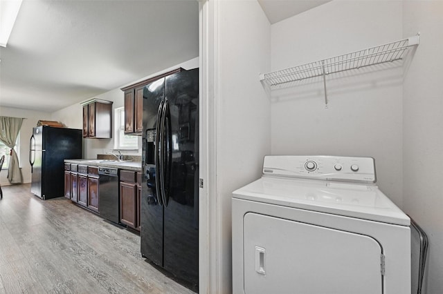 1445 Macy Ln, Dallas, TX 75253 - washroom featuring washer / dryer and light wood-type flooring
