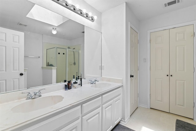 4100 Creekhollow Dr, Carrollton, TX 75010 - bathroom with a stall shower, a skylight, double vanity, and tile patterned flooring