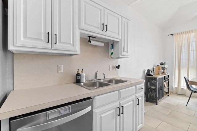 4100 Creekhollow Dr, Carrollton, TX 75010 - kitchen featuring dishwasher, a sink, white cabinets, light countertops, and lofted ceiling