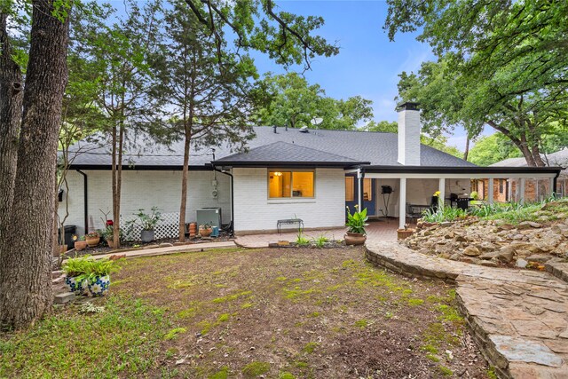 3905 Shady Creek Dr, Euless, TX 76040 - rear view of house with a patio area, a chimney, brick siding, and roof with shingles
