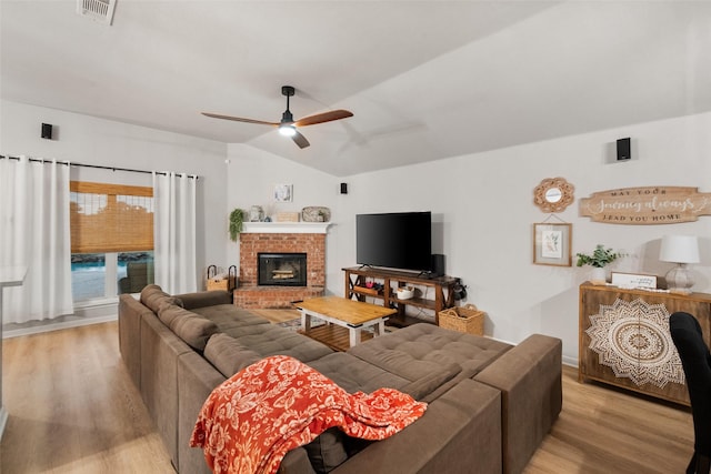 1711 Sage Dr, Midlothian, TX 76065 - living room with light wood-type flooring, ceiling fan, lofted ceiling, a brick fireplace, and baseboards