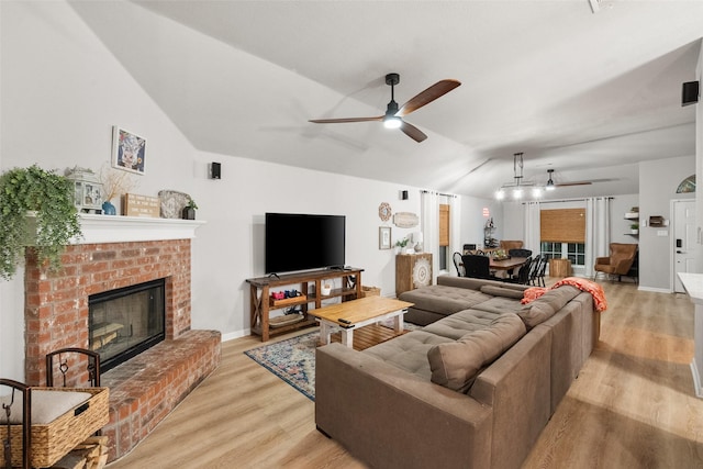 1711 Sage Dr, Midlothian, TX 76065 - living area with ceiling fan, vaulted ceiling, light wood-type flooring, and a brick fireplace