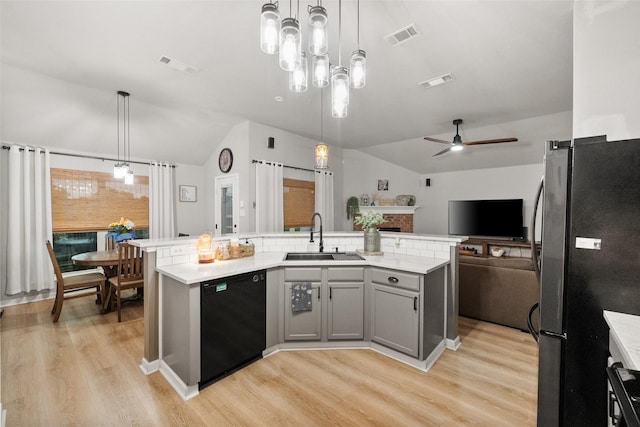 1711 Sage Dr, Midlothian, TX 76065 - kitchen featuring dishwasher, a sink, freestanding refrigerator, lofted ceiling, and light wood finished floors