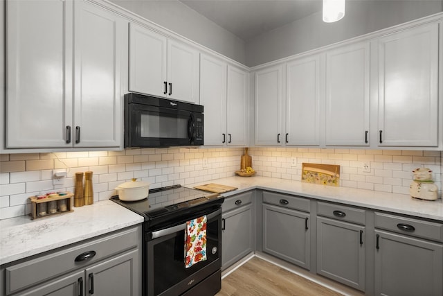 1711 Sage Dr, Midlothian, TX 76065 - kitchen featuring stainless steel range with electric cooktop, black microwave, gray cabinetry, and backsplash