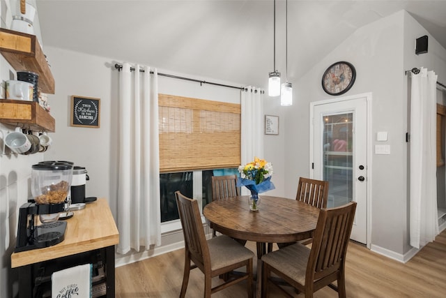 1711 Sage Dr, Midlothian, TX 76065 - dining room with light wood-style flooring, vaulted ceiling, and baseboards