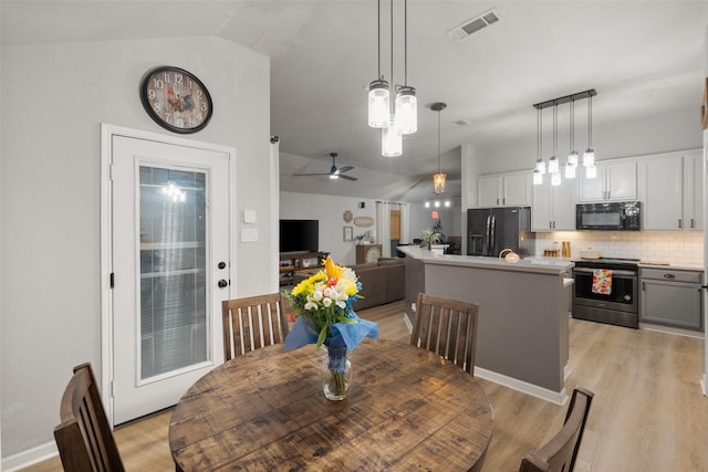 1711 Sage Dr, Midlothian, TX 76065 - dining area with vaulted ceiling, light wood-type flooring, and ceiling fan