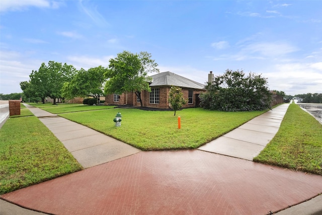 1711 Sage Dr, Midlothian, TX 76065 - view of front of house featuring a front yard, a chimney, and brick siding