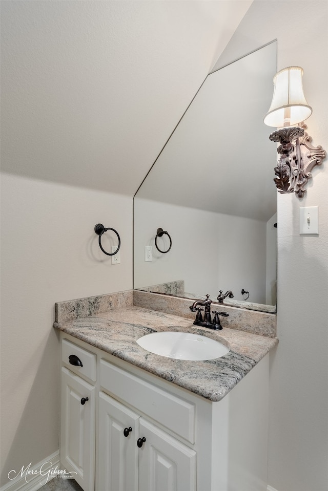 145 Carondelet Ct, Bossier City, LA 71111 - bathroom featuring vanity, lofted ceiling, and baseboards