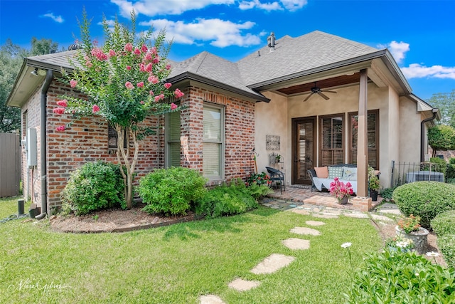 145 Carondelet Ct, Bossier City, LA 71111 - view of front of house featuring a ceiling fan, stucco siding, brick siding, roof with shingles, and cooling unit