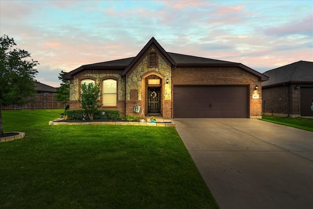 609 Autumn Ave, Justin, TX 76247 - view of front facade with driveway, brick siding, and an attached garage