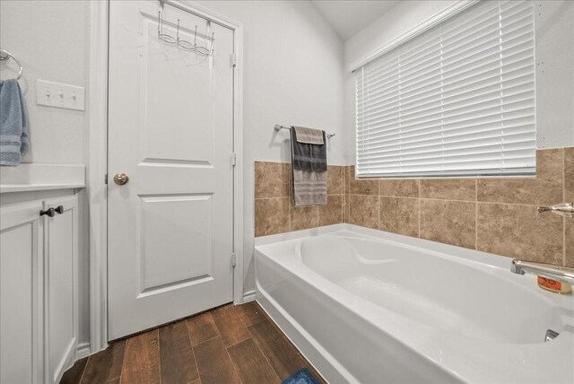 609 Autumn Ave, Justin, TX 76247 - bathroom featuring a bath and wood finished floors
