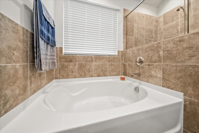 609 Autumn Ave, Justin, TX 76247 - bathroom with a bath, tile walls, and a shower