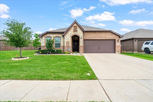 609 Autumn Ave, Justin, TX 76247 - view of front of house with a garage, concrete driveway, brick siding, and stone siding