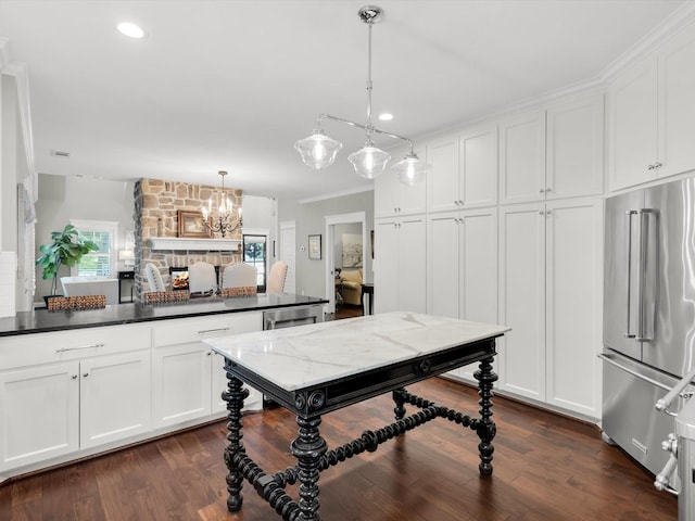 411 Jordan Farm Cir, Rockwall, TX 75087 - kitchen featuring high end refrigerator, white cabinets, a chandelier, hanging light fixtures, and dark countertops
