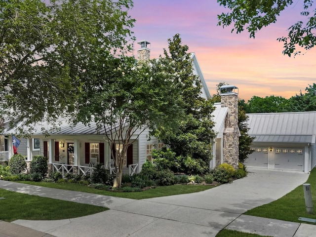 411 Jordan Farm Cir, Rockwall, TX 75087 - view of front facade with a chimney, a standing seam roof, driveway, an attached garage, and metal roof