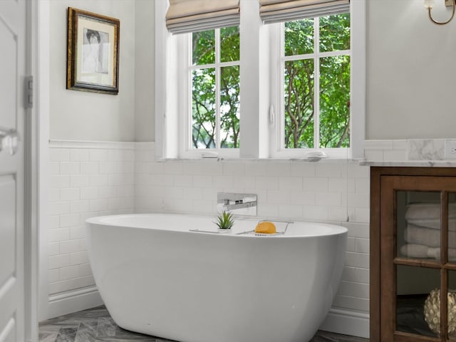 411 Jordan Farm Cir, Rockwall, TX 75087 - bathroom with tile walls, wainscoting, and a soaking tub