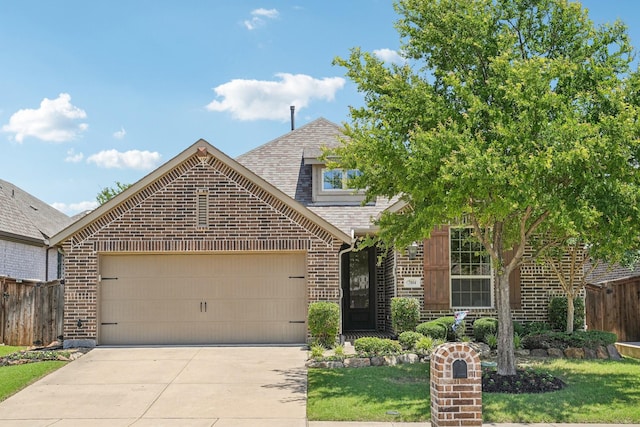 7804 Lewisville Ln, Mckinney, TX 75071 - view of front of property with brick siding, a garage, driveway, and a shingled roof