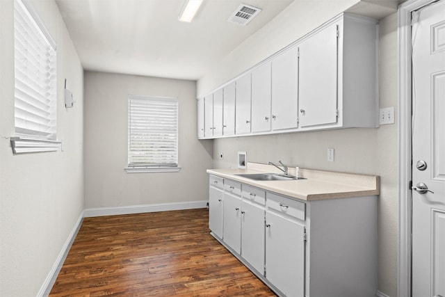 3806 Rainier St, Irving, TX 75062 - laundry area with washer hookup, dark wood-style flooring, cabinet space, baseboards, and hookup for an electric dryer