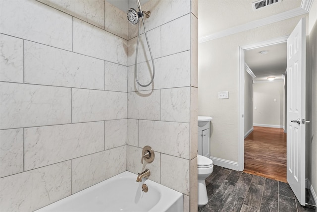 3806 Rainier St, Irving, TX 75062 - full bathroom with ornamental molding, wood finished floors, washtub / shower combination, toilet, and baseboards