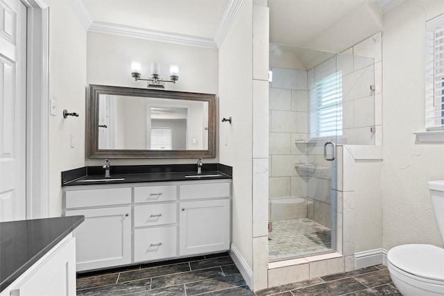 3806 Rainier St, Irving, TX 75062 - bathroom featuring toilet, double vanity, a stall shower, ornamental molding, and baseboards