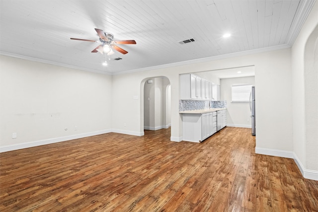 3806 Rainier St, Irving, TX 75062 - unfurnished living room with arched walkways, a ceiling fan, wood-type flooring, crown molding, and baseboards