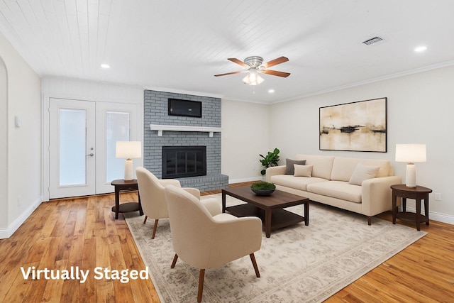 3806 Rainier St, Irving, TX 75062 - living area featuring baseboards, light wood finished floors, a ceiling fan, a fireplace, and recessed lighting
