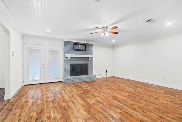 3806 Rainier St, Irving, TX 75062 - unfurnished living room featuring hardwood / wood-style floors, arched walkways, ceiling fan, ornamental molding, and baseboards