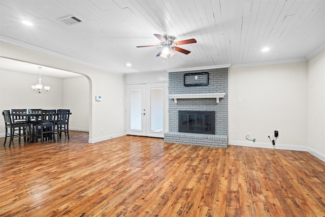 3806 Rainier St, Irving, TX 75062 - living room featuring a ceiling fan, wood finished floors, a chandelier, arched walkways, and baseboards