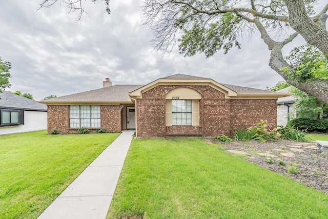 1538 Sunswept Ter, Lewisville, TX 75077 - ranch-style house with brick siding, a front lawn, a chimney, and a shingled roof