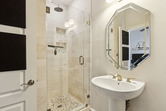 2022 N Fitzhugh Ave Unit E, Dallas, TX 75204 - bathroom with a shower stall, a sink, and a textured wall