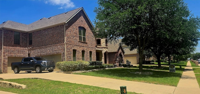 535 Cedarbird Trl, Murphy, TX 75094 - view of front of home with brick siding, an attached garage, a front lawn, and driveway