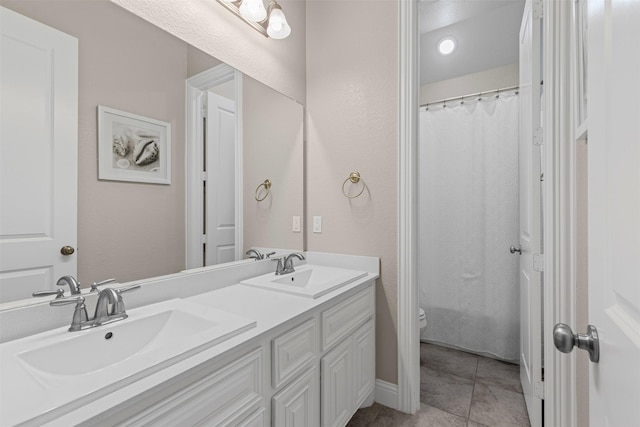 945 Colby Bluff Dr, Rockwall, TX 75087 - full bathroom featuring toilet, double vanity, a shower with curtain, and tile patterned floors