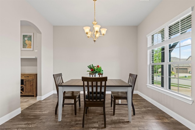 945 Colby Bluff Dr, Rockwall, TX 75087 - dining space featuring a chandelier, wood finished floors, baseboards, and arched walkways