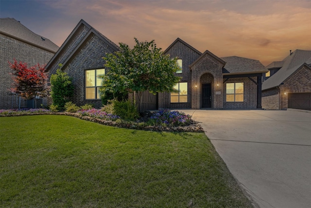 945 Colby Bluff Dr, Rockwall, TX 75087 - french country inspired facade featuring brick siding, concrete driveway, and a lawn
