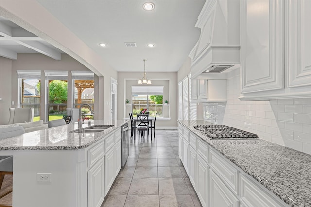 945 Colby Bluff Dr, Rockwall, TX 75087 - kitchen with a sink, premium range hood, appliances with stainless steel finishes, decorative backsplash, and white cabinets