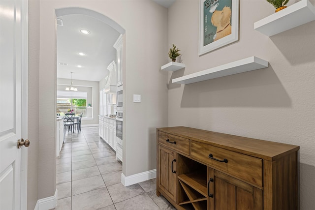 945 Colby Bluff Dr, Rockwall, TX 75087 - corridor featuring arched walkways, light tile patterned floors, recessed lighting, and baseboards