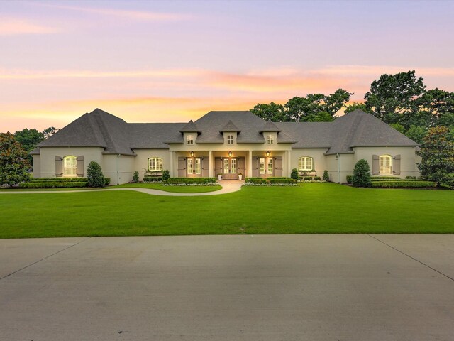 2161 Honey Ln, Celina, TX 75009 - french country inspired facade featuring french doors, a front lawn, and stucco siding