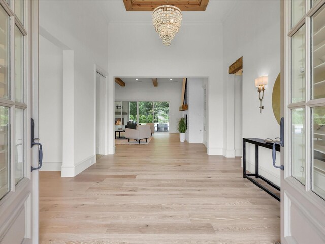 2161 Honey Ln, Celina, TX 75009 - entryway featuring a chandelier, light wood-type flooring, baseboards, and crown molding