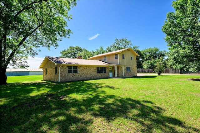 10335 Nolan Dr, Tyler, TX 75709 - back of property featuring brick siding and a chimney
