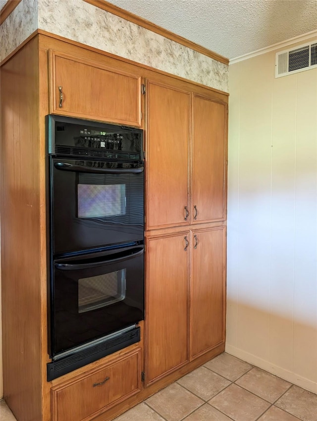 10335 Nolan Dr, Tyler, TX 75709 - kitchen with ornamental molding, brown cabinets, a textured ceiling, and light tile patterned flooring
