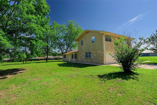 10335 Nolan Dr, Tyler, TX 75709 - view of property exterior with concrete driveway, brick siding, an attached garage, and a yard