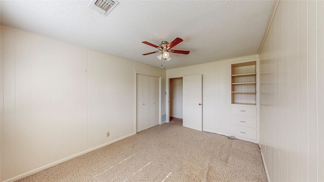 10335 Nolan Dr, Tyler, TX 75709 - unfurnished bedroom with a textured ceiling, light carpet, a ceiling fan, a closet, and baseboards