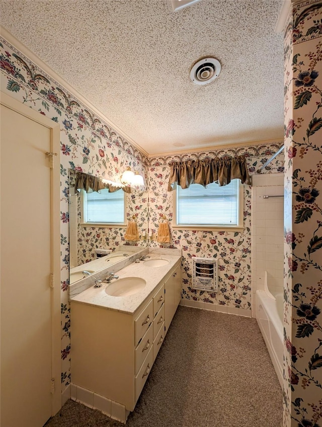 10335 Nolan Dr, Tyler, TX 75709 - full bathroom with double vanity, a textured ceiling, wallpapered walls, heating unit, and bathing tub / shower combination