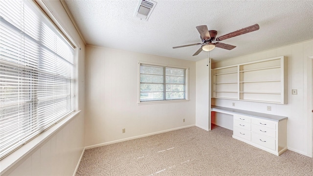 10335 Nolan Dr, Tyler, TX 75709 - unfurnished office featuring a textured ceiling, a ceiling fan, light colored carpet, and baseboards