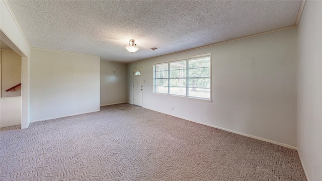 10335 Nolan Dr, Tyler, TX 75709 - carpeted spare room featuring a textured ceiling and baseboards